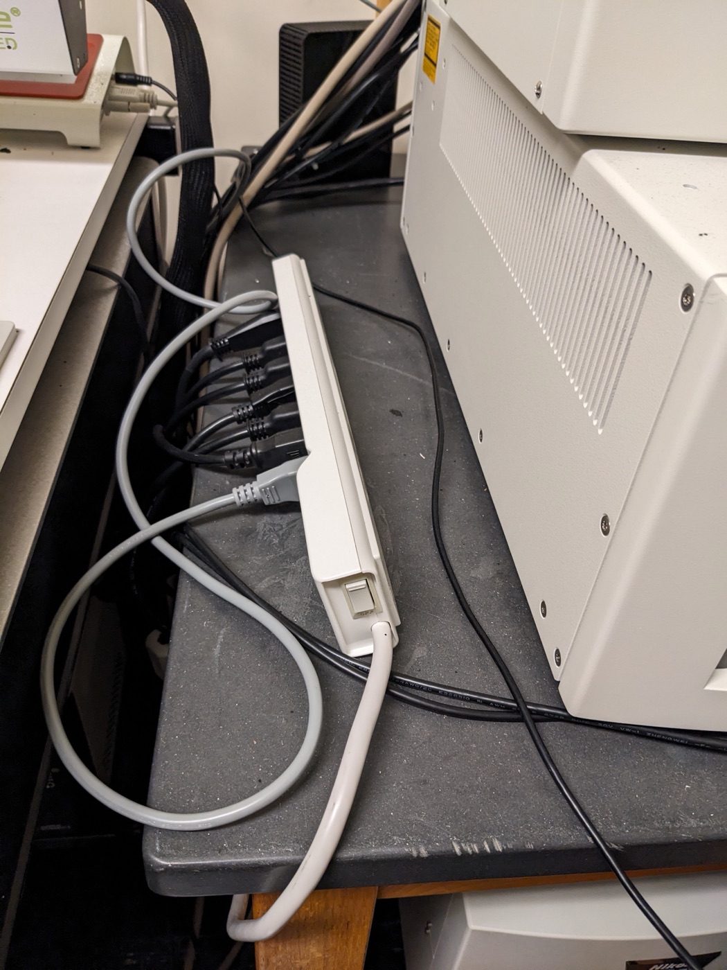 Switch on the power strip to switch on the microscope